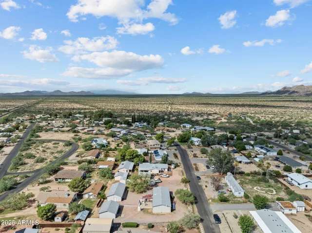 an aerial view of a city with lots of residential buildings and ocean view in back
