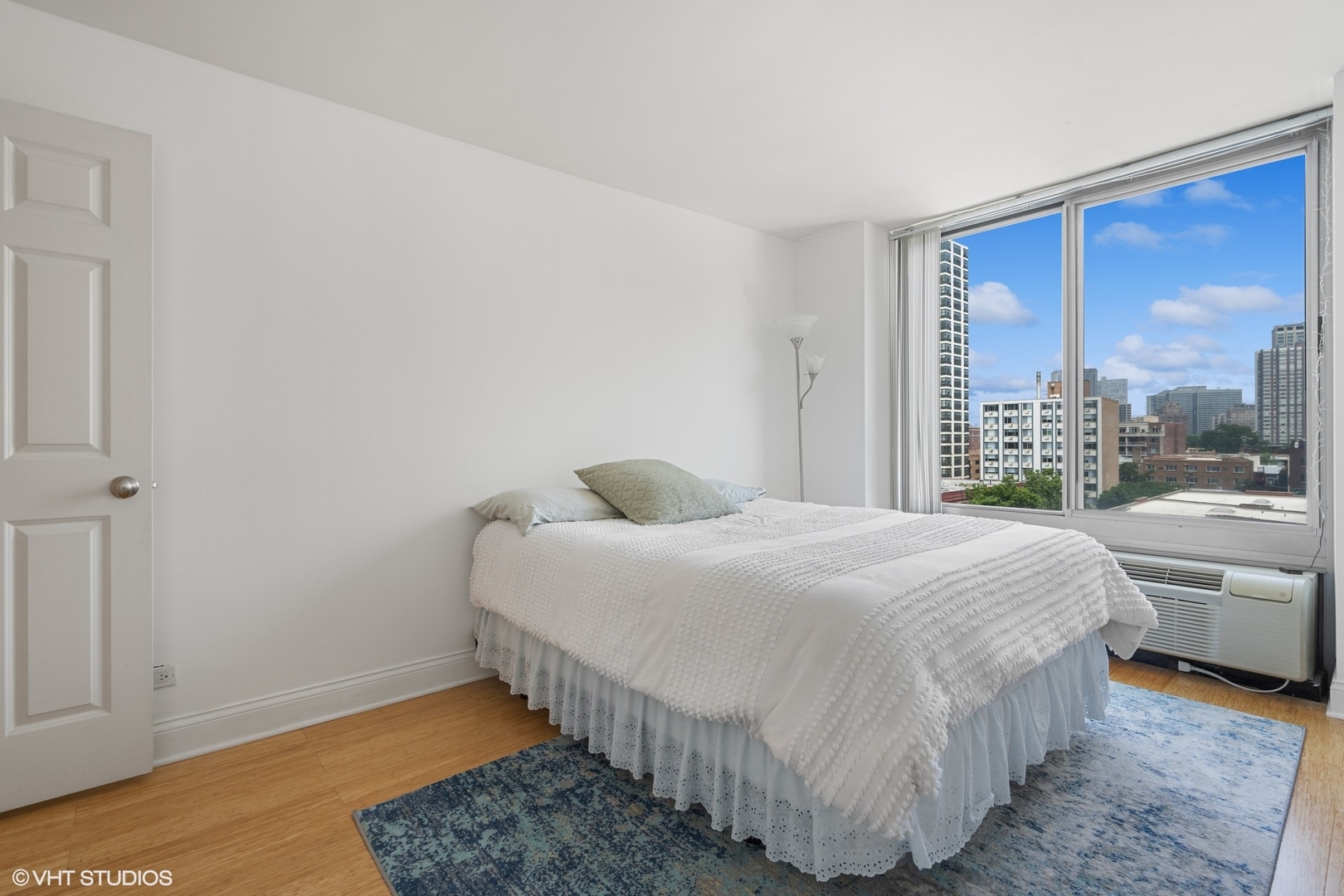 450 West Briar Place, Unit 7B Chicago, IL 60657 - Photo 11 of 15 a bedroom with a bed and a large window