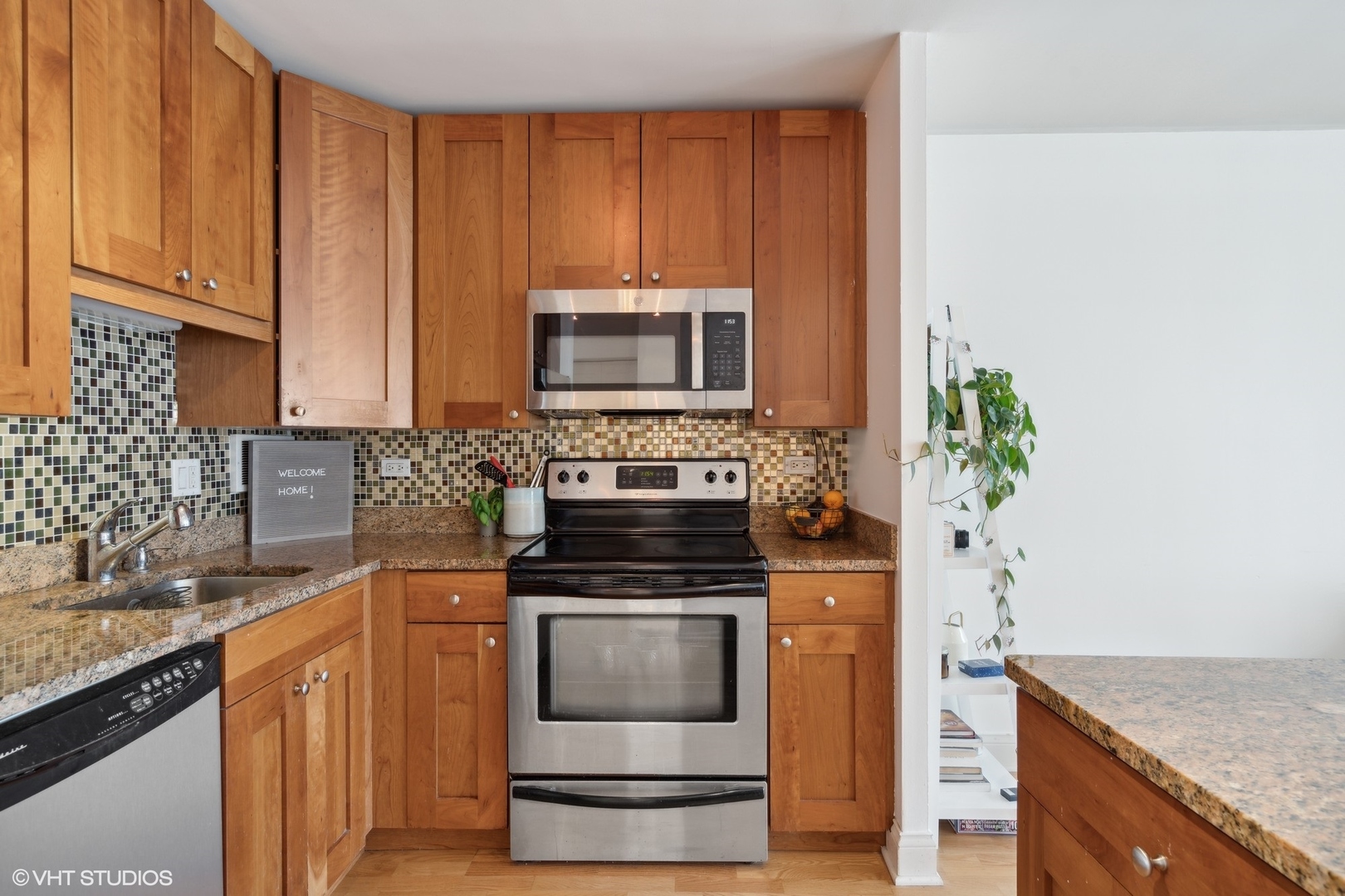 450 West Briar Place, Unit 7B Chicago, IL 60657 - Photo 8 of 15 a kitchen with granite countertop a stove sink and microwave