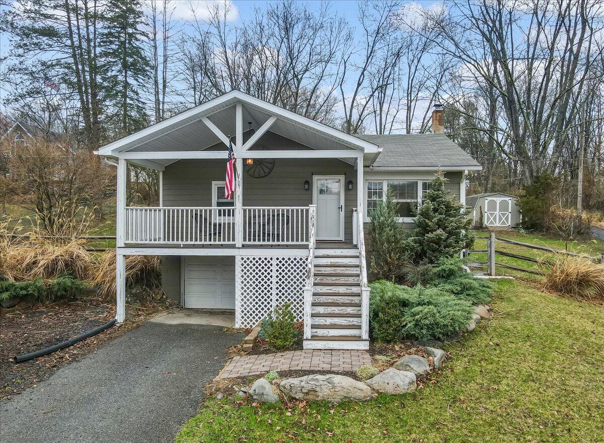 5039 Running Valley Road Stroudsburg, PA 18360 - Photo 1 of 65 a front view of a house with garden