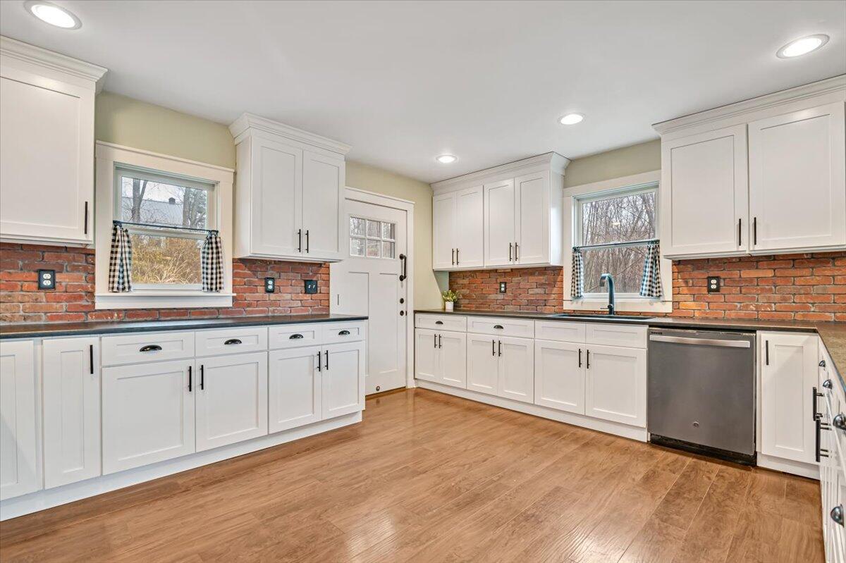 5039 Running Valley Road Stroudsburg, PA 18360 - Photo 15 of 65 a kitchen with granite countertop white cabinets a sink a window and stainless steel appliances