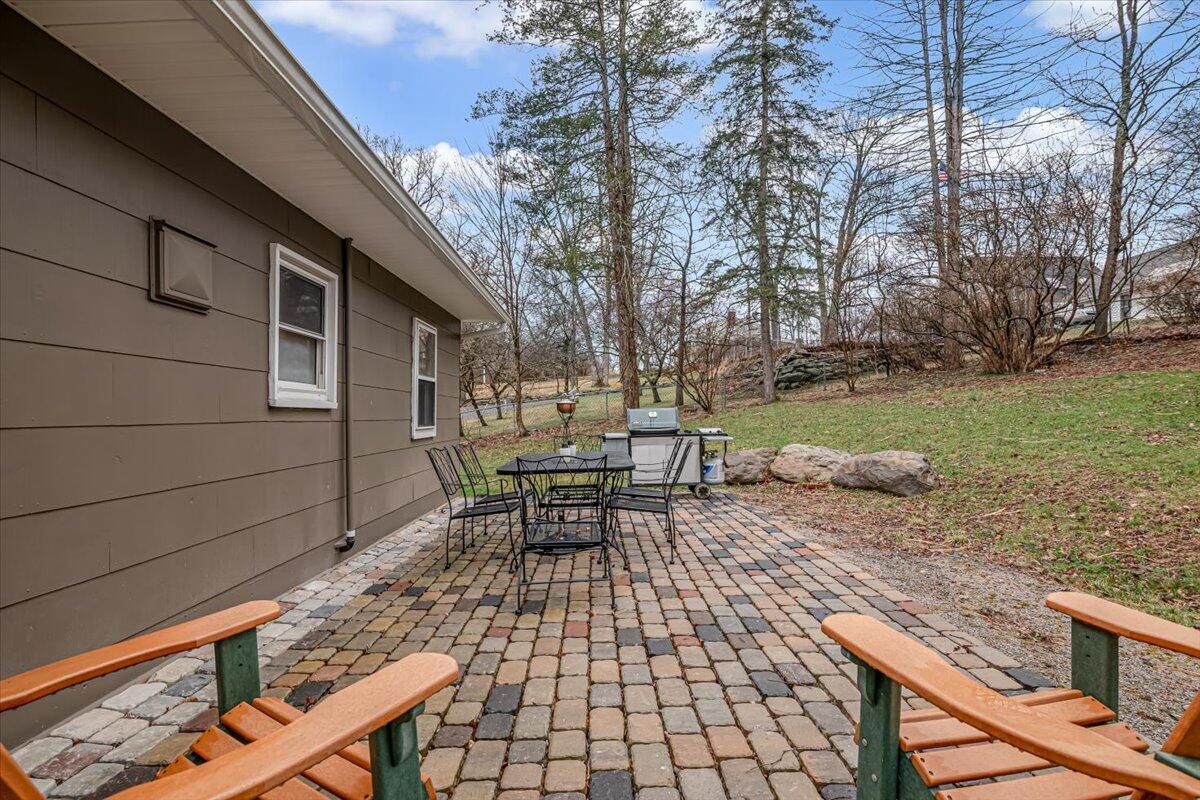 5039 Running Valley Road Stroudsburg, PA 18360 - Photo 34 of 65 a backyard of a house with table and chairs