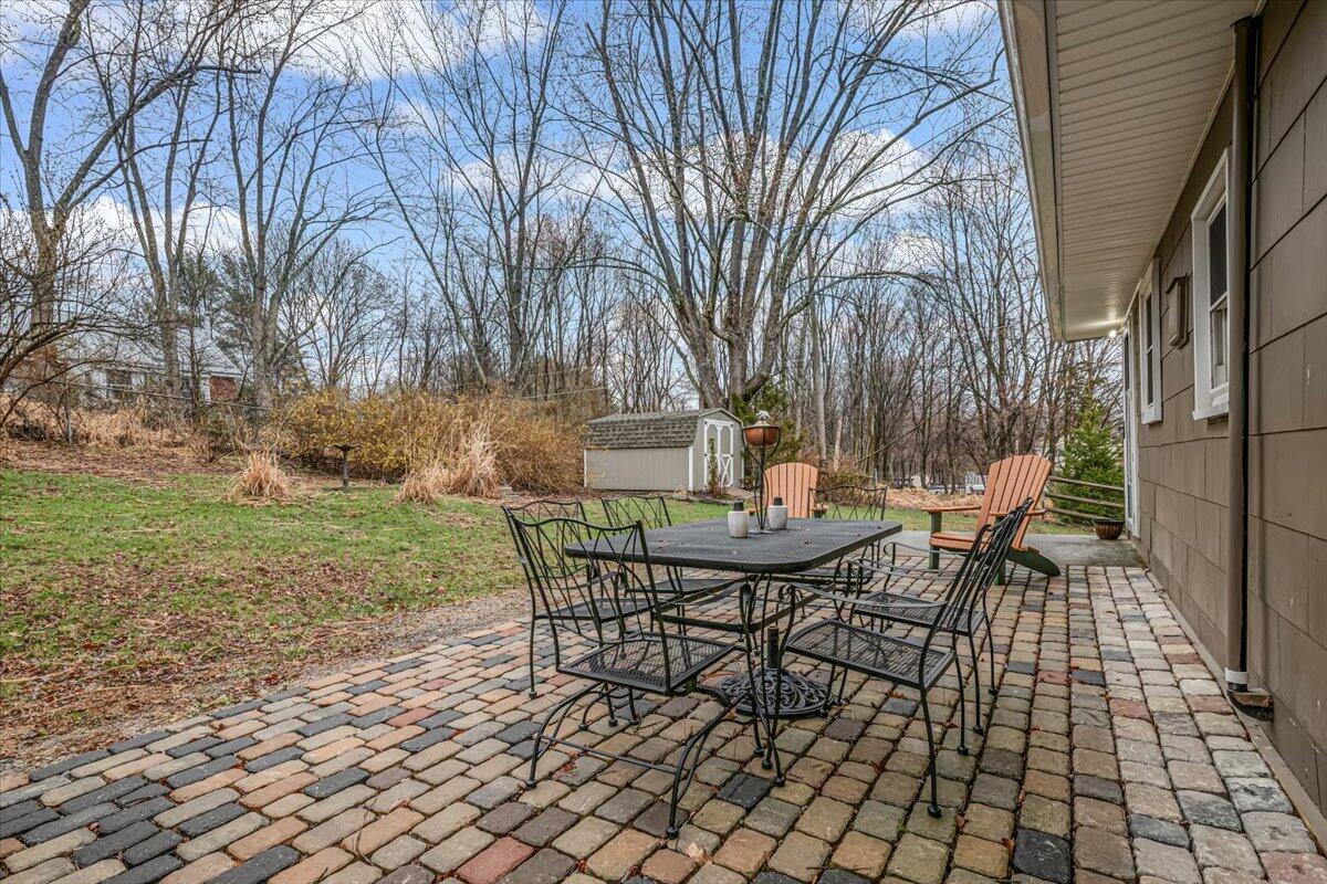 5039 Running Valley Road Stroudsburg, PA 18360 - Photo 38 of 65 a view of a backyard with table and chairs and a fire pit