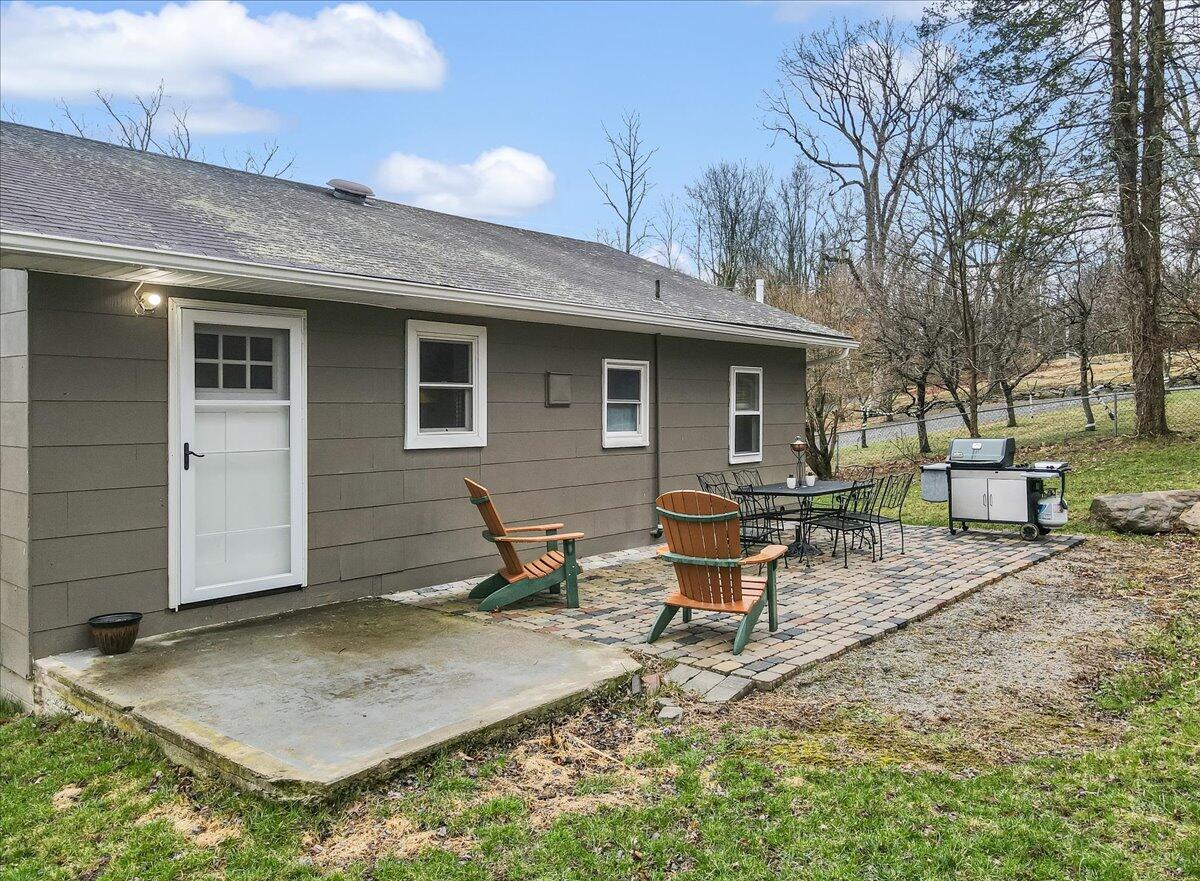 5039 Running Valley Road Stroudsburg, PA 18360 - Photo 39 of 65 a view of a backyard with table and chairs and wooden fence
