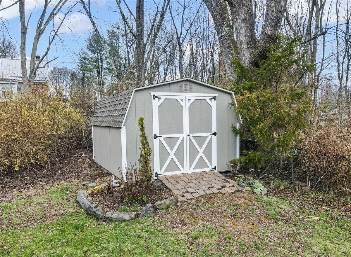 5039 Running Valley Road Stroudsburg, PA 18360 - Photo 50 of 65 a front view of a house with garden