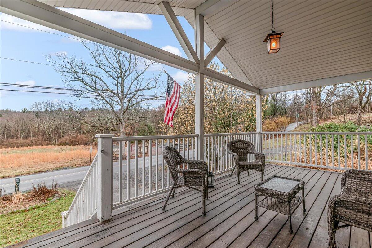 5039 Running Valley Road Stroudsburg, PA 18360 - Photo 5 of 65 a view of a balcony with lake view and wooden floor