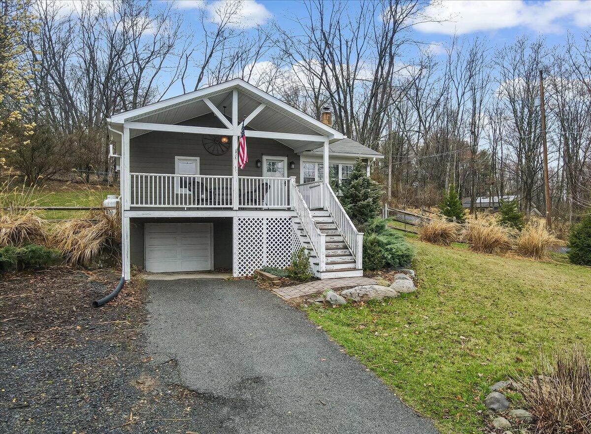 5039 Running Valley Road Stroudsburg, PA 18360 - Photo 51 of 65 a front view of a house with a yard