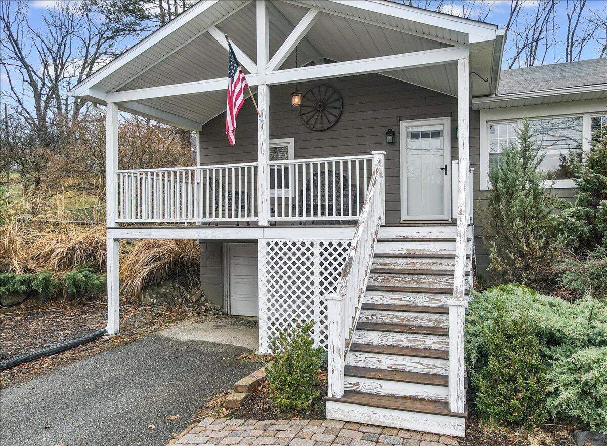 5039 Running Valley Road Stroudsburg, PA 18360 - Photo 59 of 65 a view of a house with a deck and a yard