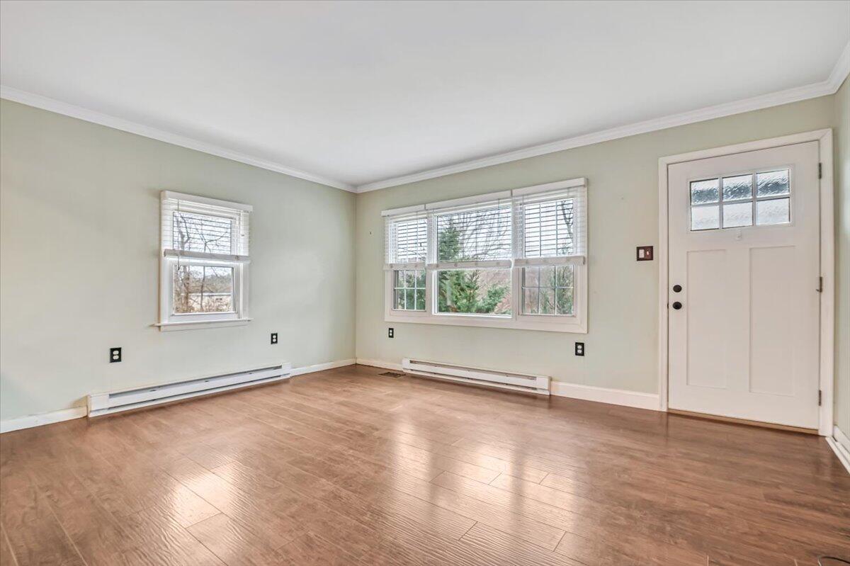 5039 Running Valley Road Stroudsburg, PA 18360 - Photo 8 of 65 a view of an empty room with wooden floor and windows