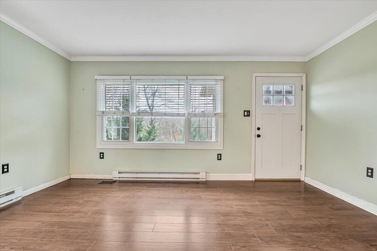 5039 Running Valley Road Stroudsburg, PA 18360 - Photo 9 of 65 an empty room with wooden floor and windows
