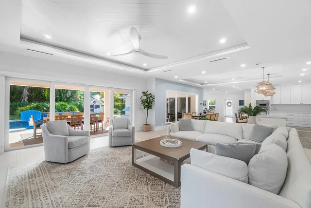 a bathroom with a granite countertop sink a toilet a mirror and shower
