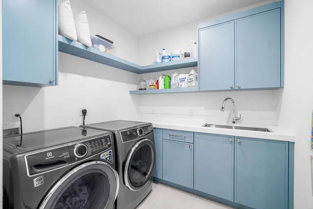 a backyard of a house with plants and large trees