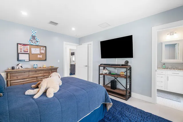 an aerial view of residential houses with outdoor space and trees
