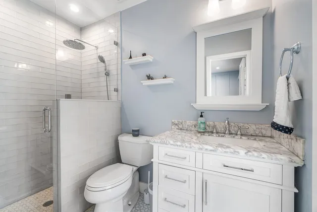 an aerial view of residential houses with outdoor space and trees