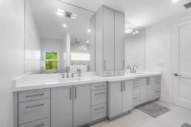 an aerial view of residential houses with outdoor space and trees all around