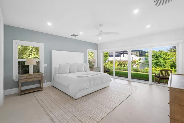 an aerial view of residential houses with outdoor space and trees all around