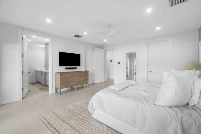 an aerial view of residential houses with outdoor space and trees all around