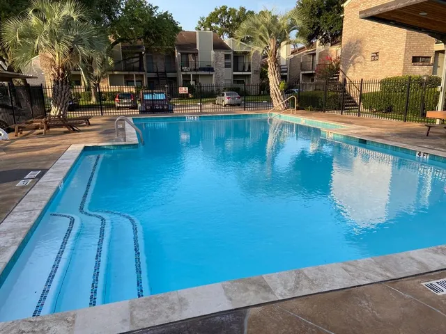 a view of a swimming pool with sitting area