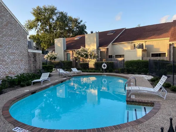a view of a swimming pool with a patio