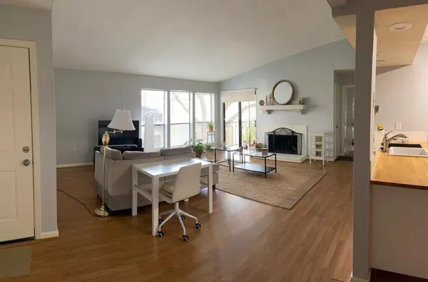 a living room with furniture a fireplace and a flat screen tv