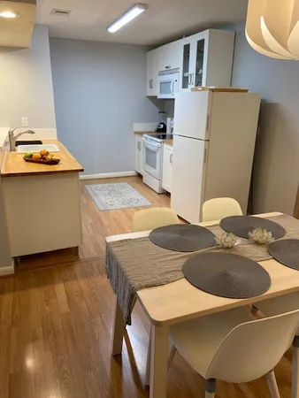 a kitchen with stainless steel appliances granite countertop a sink a stove and refrigerator