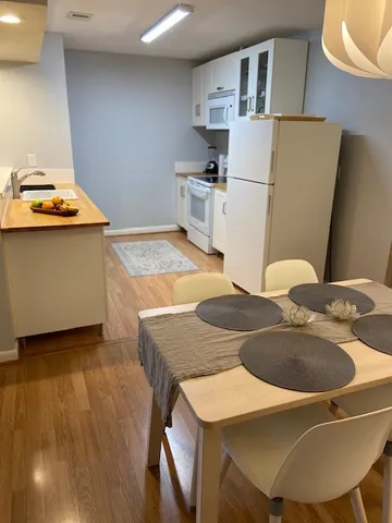 a kitchen with stainless steel appliances granite countertop a sink a stove and refrigerator