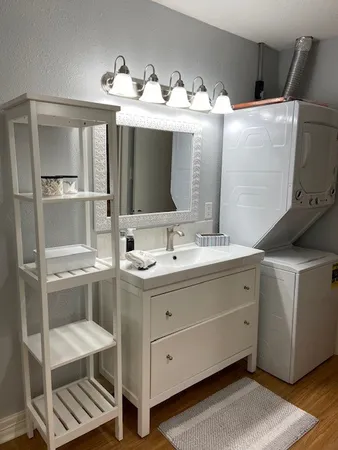 a bathroom with a double vanity sink mirror and