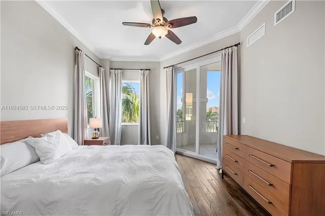 a bedroom with a large bed and a chandelier