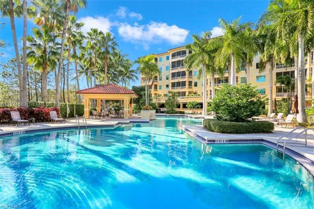 a front view of a house with swimming pool having outdoor seating