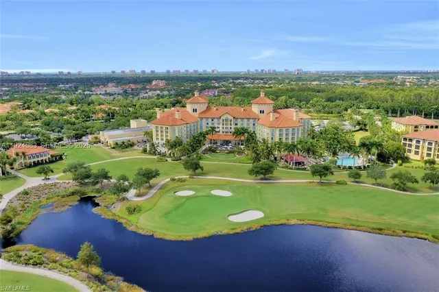 an aerial view of a house with a swimming pool big yard and mountain view in back