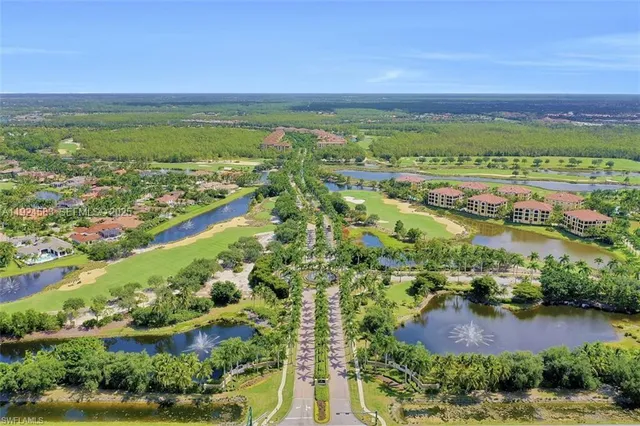an aerial view of residential houses with outdoor space and river