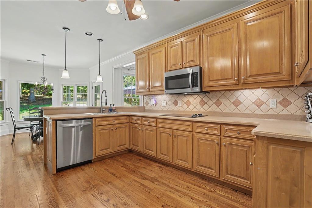 537 Old Collins Road Hoschton, GA 30548 - Photo 14 of 42 a kitchen with a sink cabinets and wooden floor