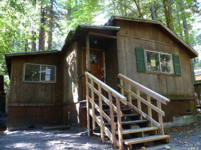 a view of wooden house with a small cabin