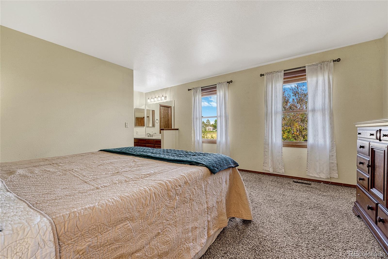 2460 Eileen Way Parker, CO 80138 - Photo 15 of 47 a bedroom with a bed and a window