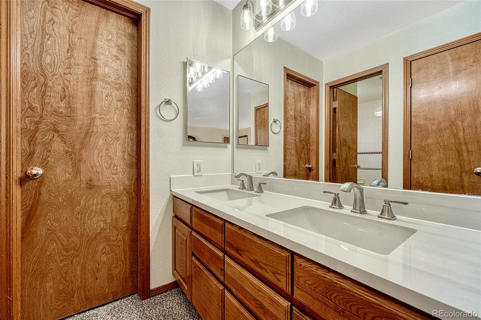 2460 Eileen Way Parker, CO 80138 - Photo 18 of 47 a bathroom with a sink and a mirror
