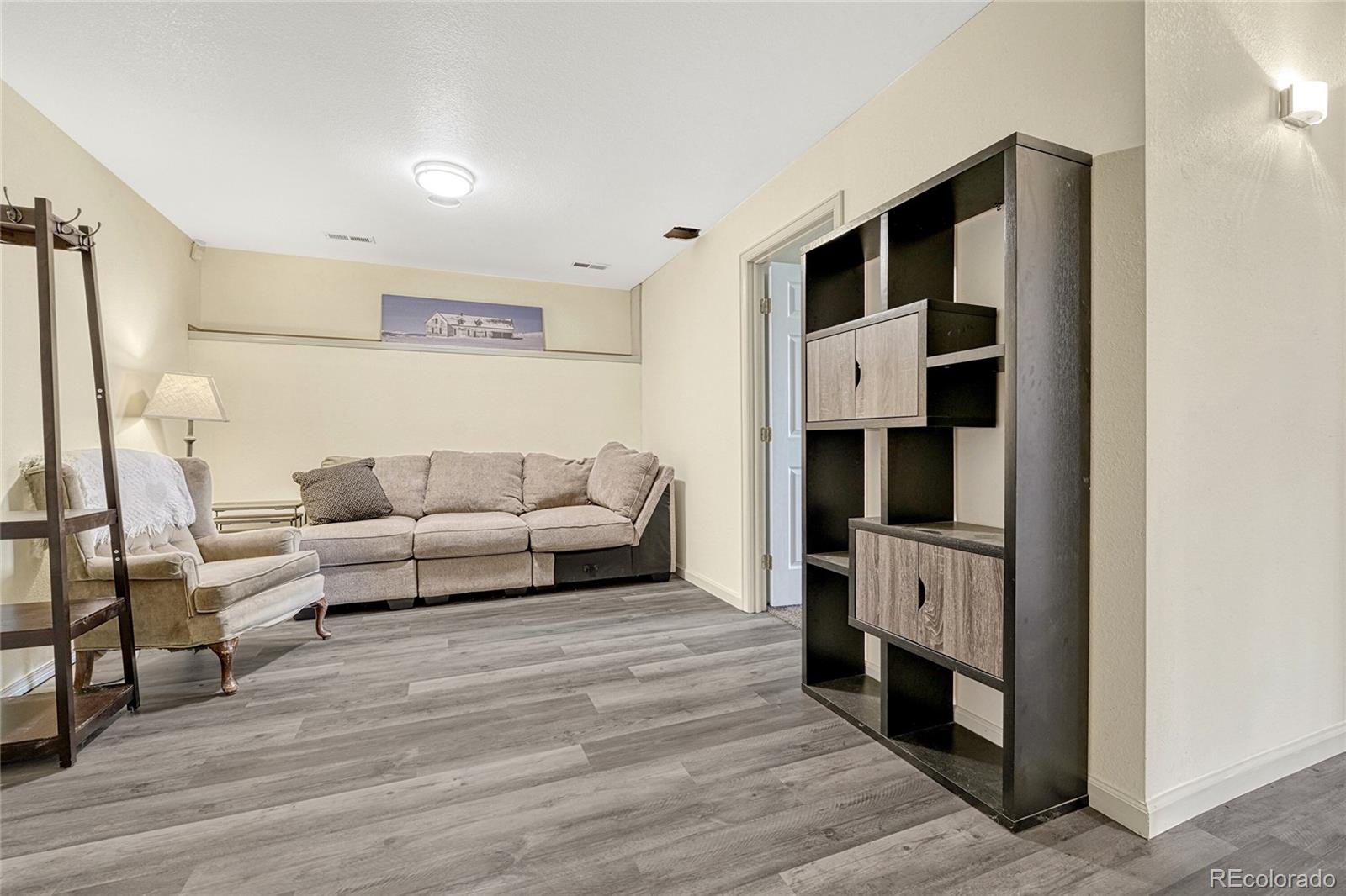 2460 Eileen Way Parker, CO 80138 - Photo 20 of 47 a living room with furniture and a fireplace