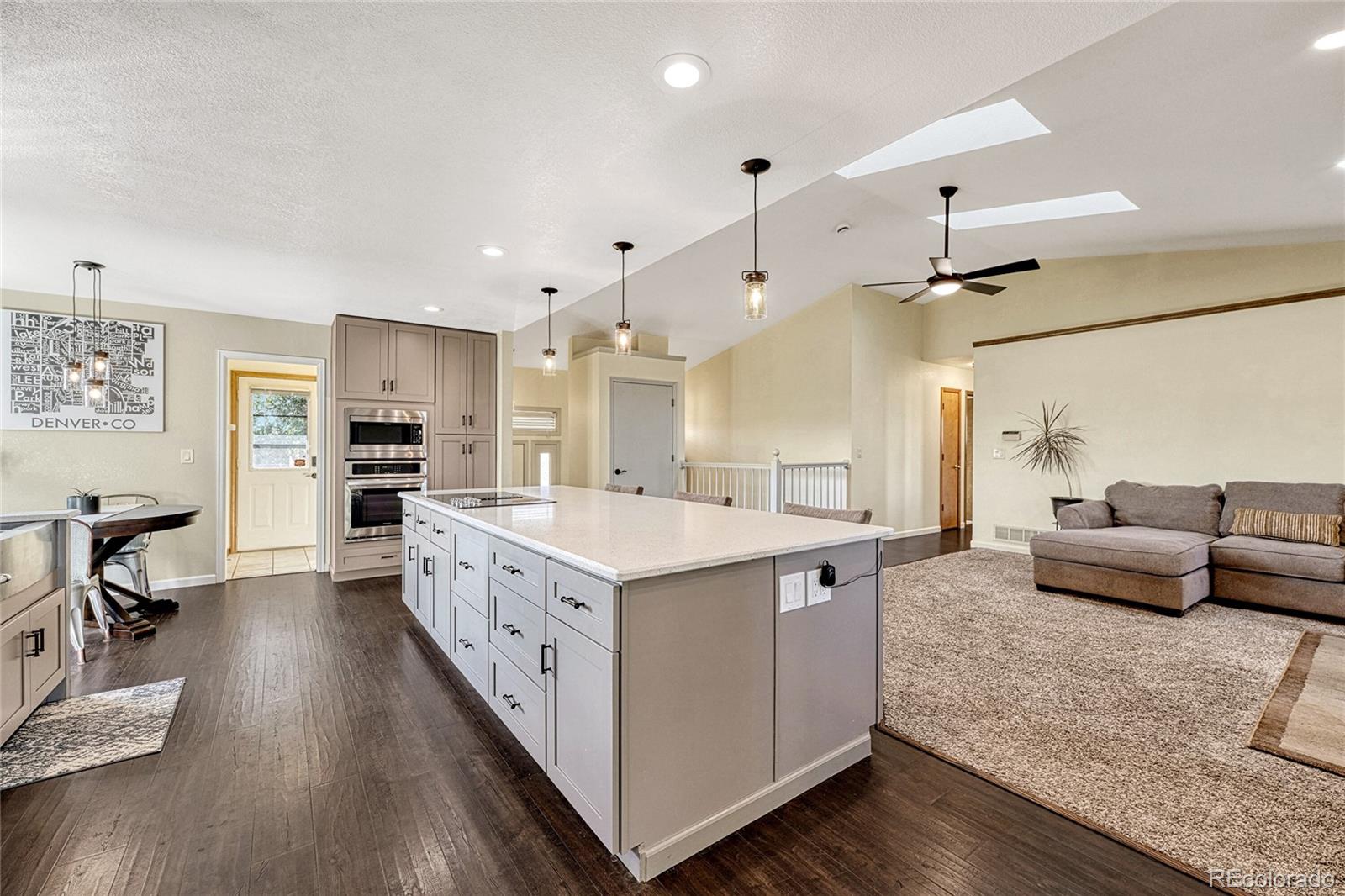 2460 Eileen Way Parker, CO 80138 - Photo 2 of 47 a large white kitchen with a large window