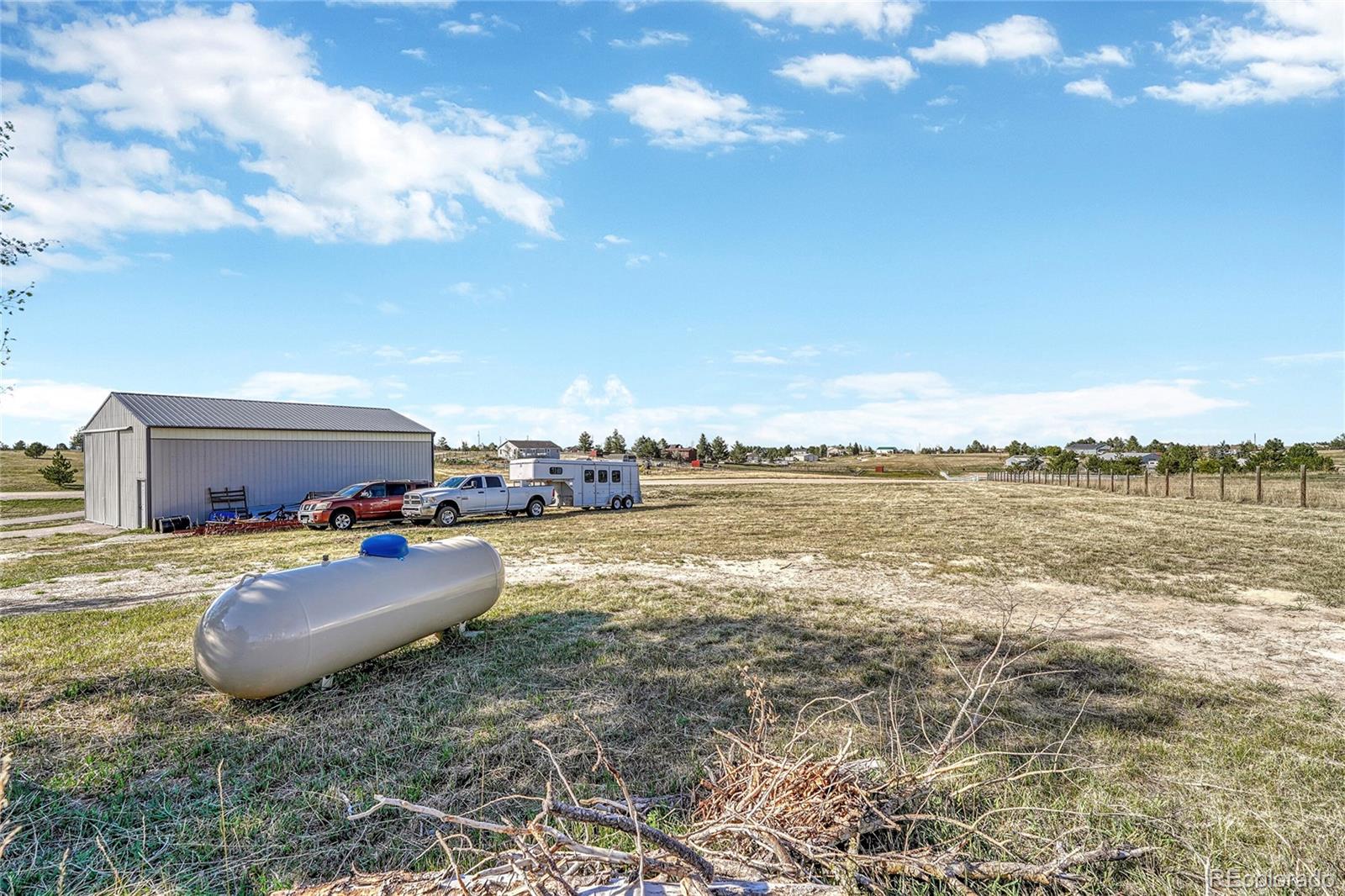 2460 Eileen Way Parker, CO 80138 - Photo 29 of 47 a view of a lake with lawn chairs