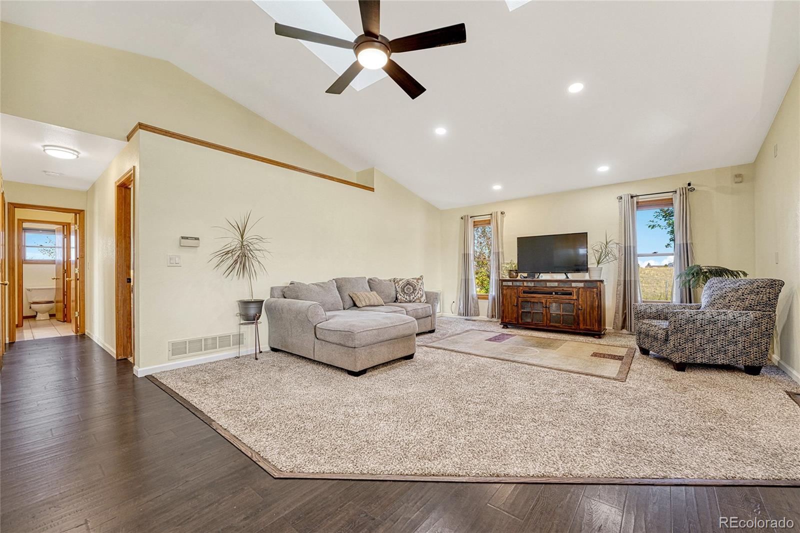 2460 Eileen Way Parker, CO 80138 - Photo 5 of 47 a living room with furniture and a flat screen tv
