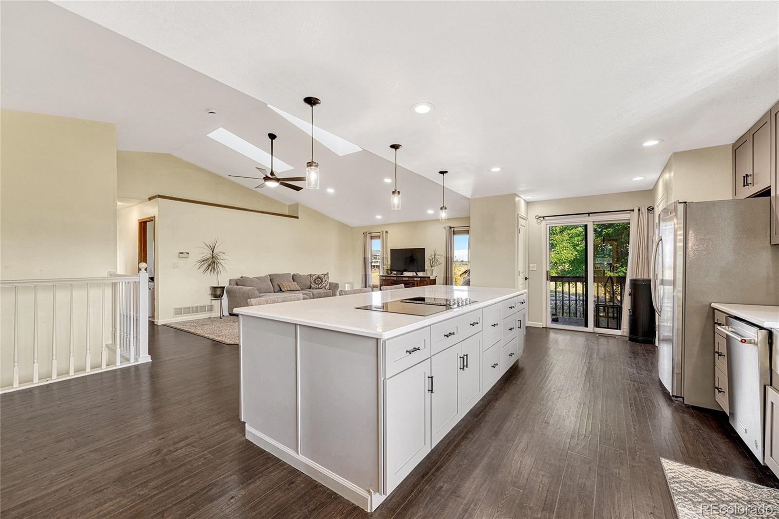 2460 Eileen Way Parker, CO 80138 - Photo 7 of 47 a large kitchen with stainless steel appliances a stove a sink dishwasher and a refrigerator