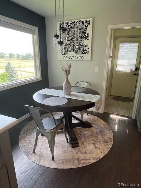 2460 Eileen Way Parker, CO 80138 - Photo 8 of 47 a view of a dining room with furniture and wooden floor