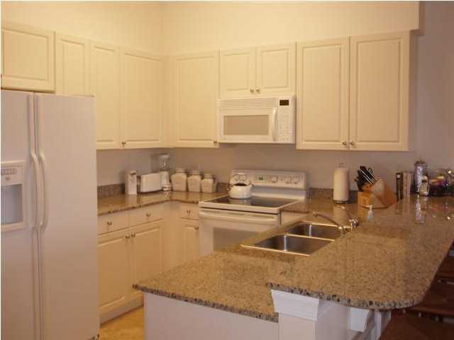 10343 East County Hwy Inlet Beach, Unit 220F 30A Inlet Beach, FL 32413 - Photo 2 of 15 a kitchen with stainless steel appliances granite countertop a sink a stove and white cabinets