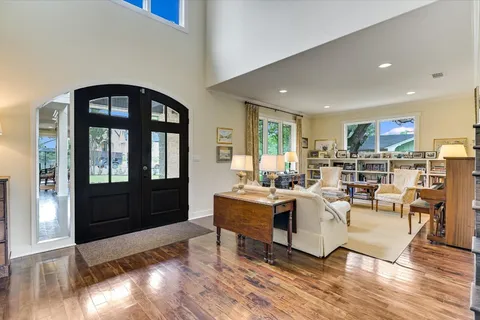 a living room with fireplace furniture and a large window