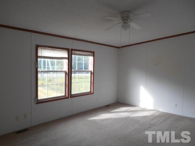 11366 Old Us 64 Spring Spring Hope, NC 27882 - Photo 5 of 12 an empty room with windows and fan