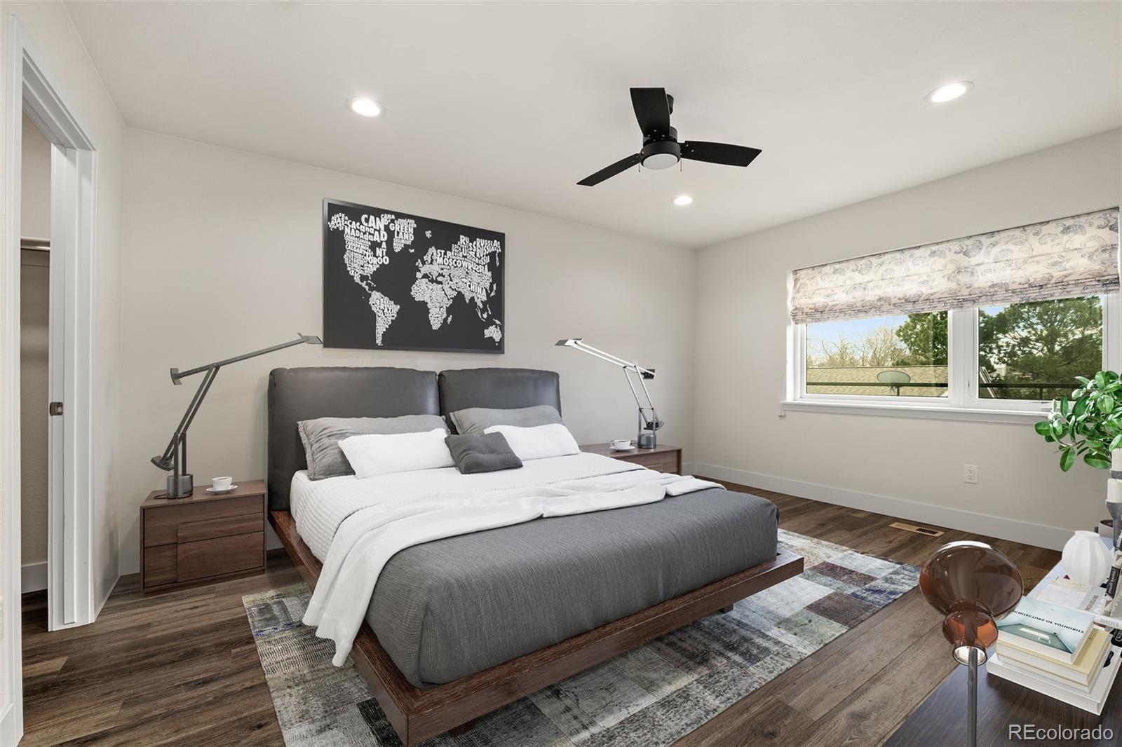 1204 South Reed Street Lakewood, CO 80232 - Photo 11 of 45 a bedroom with bed and wooden floor