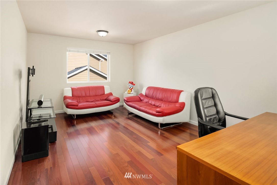 4532 Northeast 10th Street Renton, WA 98059 - Photo 15 of 24 a bedroom with furniture and a wooden floor