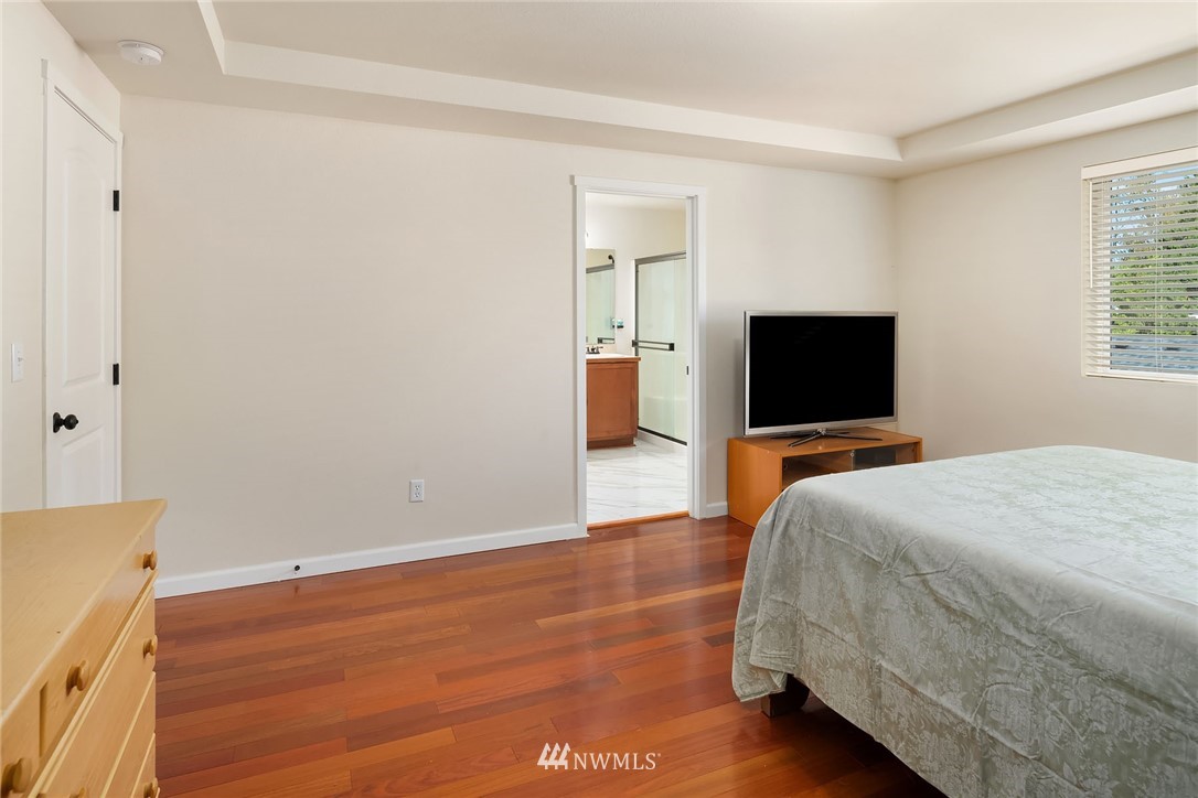 4532 Northeast 10th Street Renton, WA 98059 - Photo 17 of 24 a bedroom with a bed and a flat screen tv