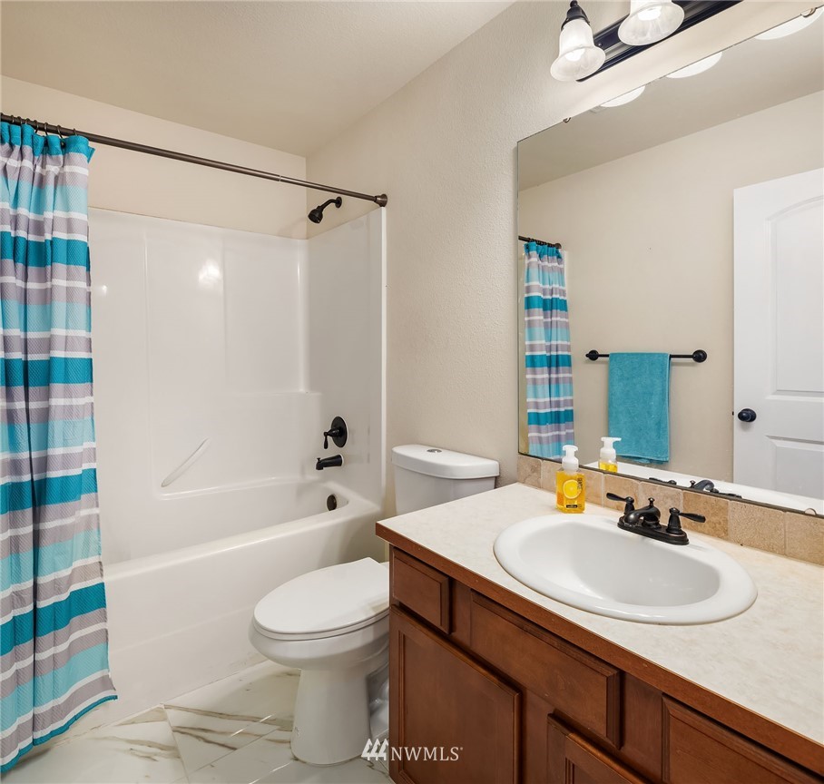 4532 Northeast 10th Street Renton, WA 98059 - Photo 22 of 24 a bathroom with a sink toilet and shower