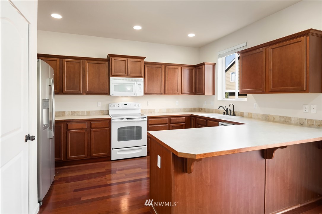 4532 Northeast 10th Street Renton, WA 98059 - Photo 5 of 24 a kitchen with a sink cabinets and wooden floor