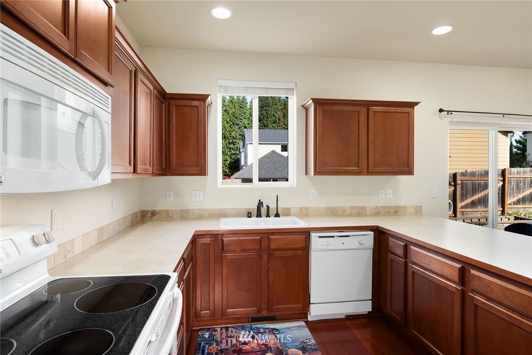 4532 Northeast 10th Street Renton, WA 98059 - Photo 6 of 24 a kitchen with a sink stove and cabinets